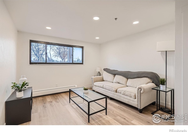 living room featuring light wood-type flooring and baseboard heating