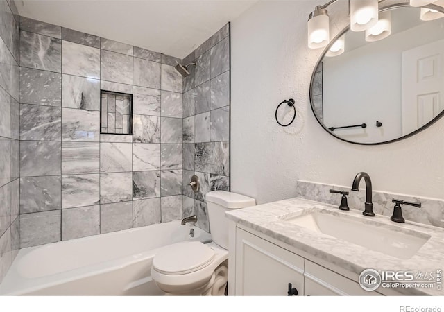 full bathroom featuring vanity, toilet, and tiled shower / bath