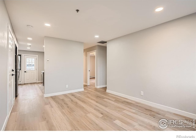 unfurnished room with light wood-type flooring