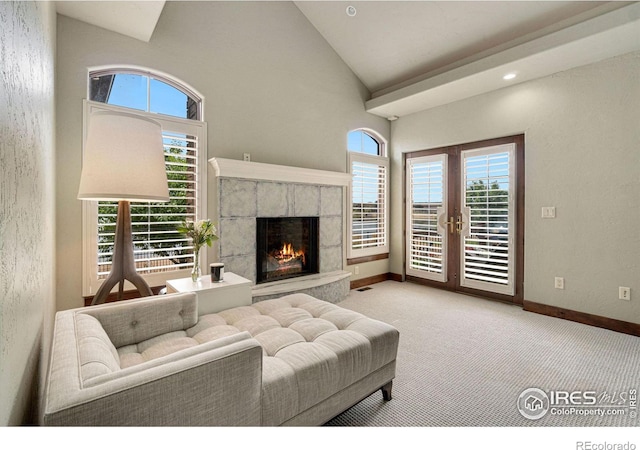 living room with plenty of natural light, light colored carpet, and french doors