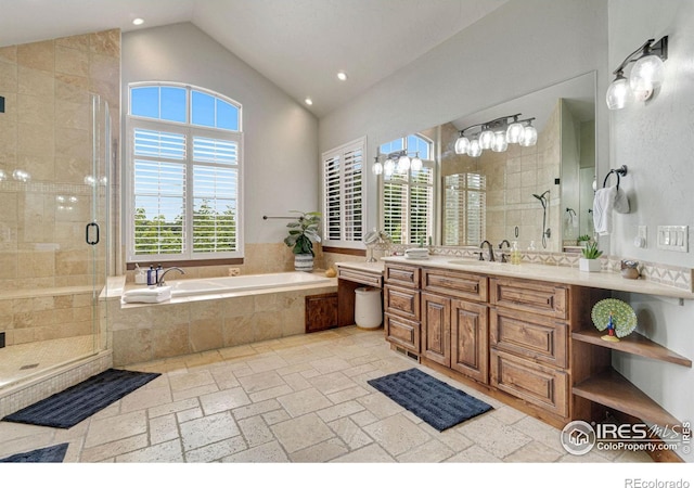 bathroom featuring vanity, plus walk in shower, and vaulted ceiling