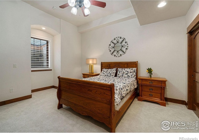 bedroom with ceiling fan and light carpet