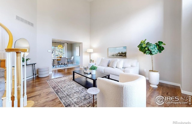 living room featuring hardwood / wood-style floors and a high ceiling