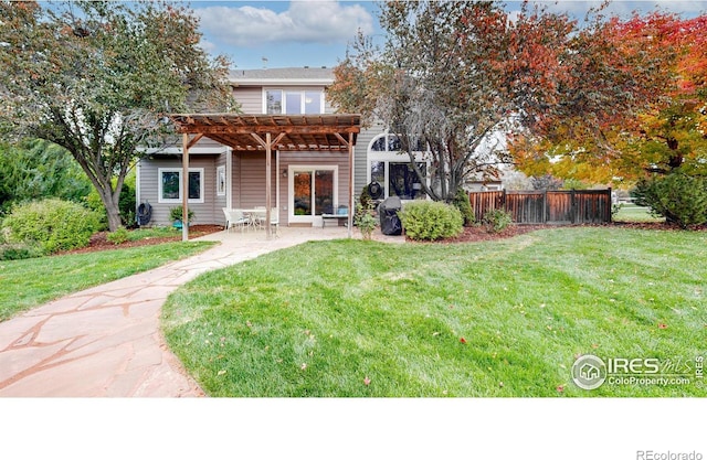 back of house with a pergola, a patio area, and a lawn