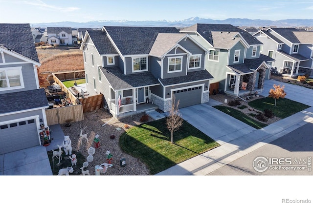 view of front of house with a mountain view, a front yard, and a garage