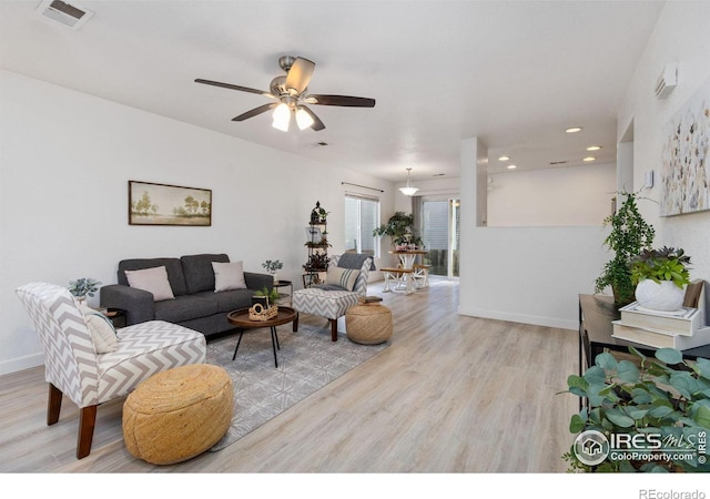 living room with ceiling fan and light wood-type flooring