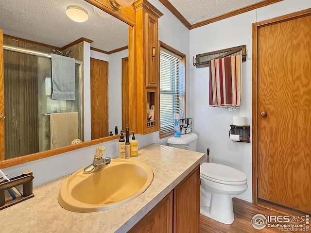 bathroom featuring crown molding, an enclosed shower, wood-type flooring, and a textured ceiling