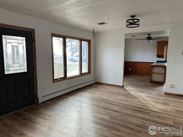 entryway with baseboards, a baseboard radiator, visible vents, and light wood-style floors