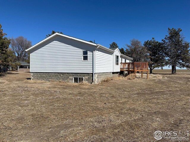 view of side of home with a deck