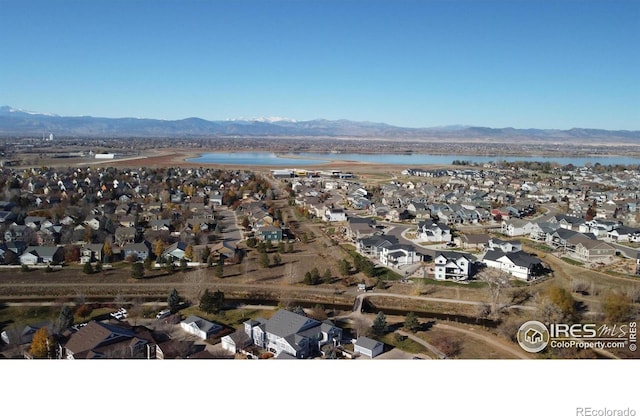 drone / aerial view with a residential view and a water and mountain view