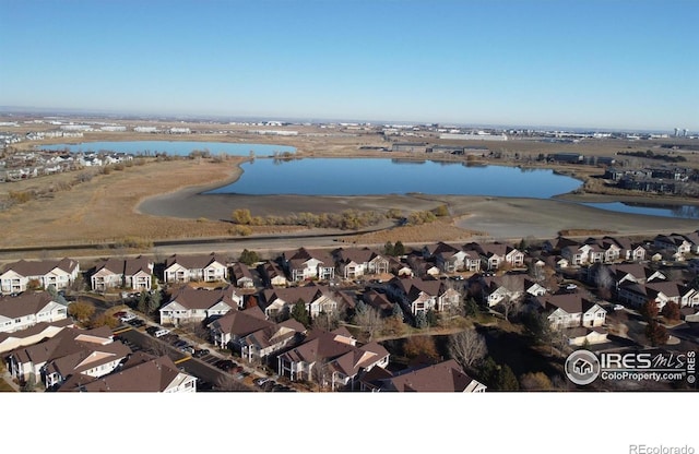 drone / aerial view featuring a water view and a residential view