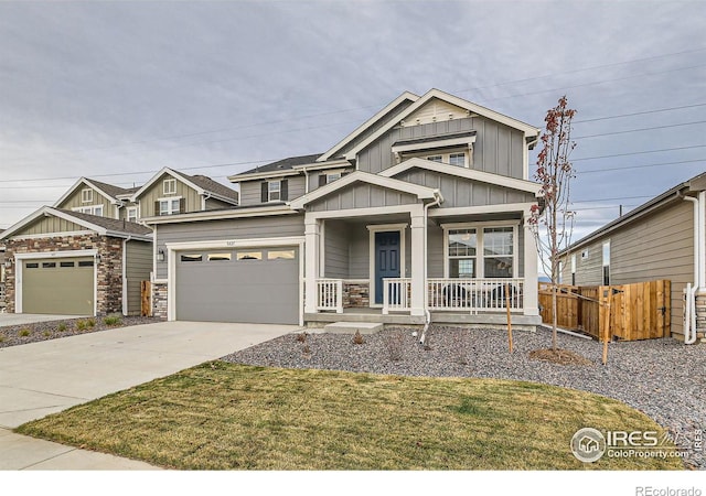 craftsman-style home featuring covered porch, a garage, and a front lawn