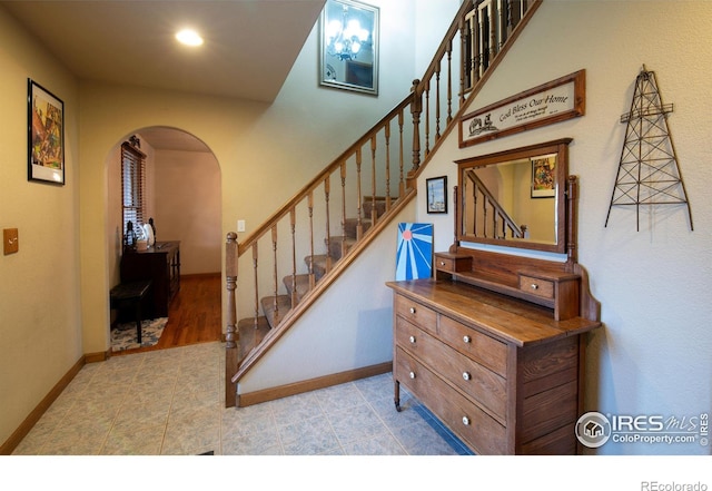 stairway with hardwood / wood-style floors