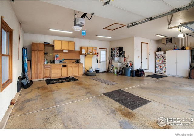 garage with a workshop area and a garage door opener