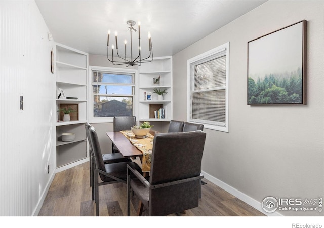 dining room featuring hardwood / wood-style flooring and a notable chandelier