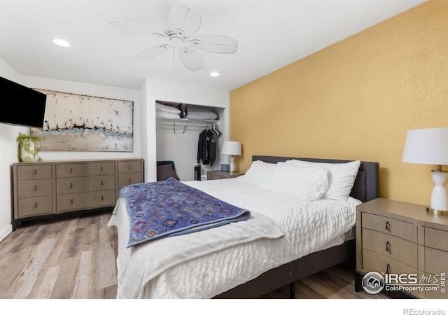 bedroom with ceiling fan, light hardwood / wood-style floors, and a closet