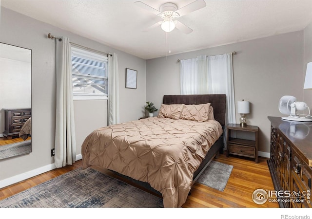 bedroom with ceiling fan and light wood-type flooring