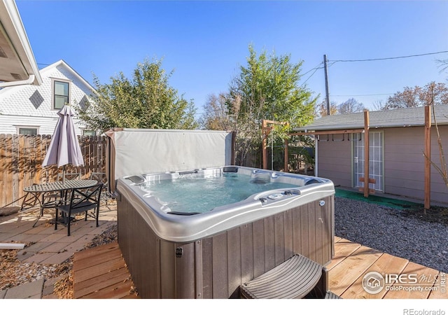 wooden deck with a hot tub