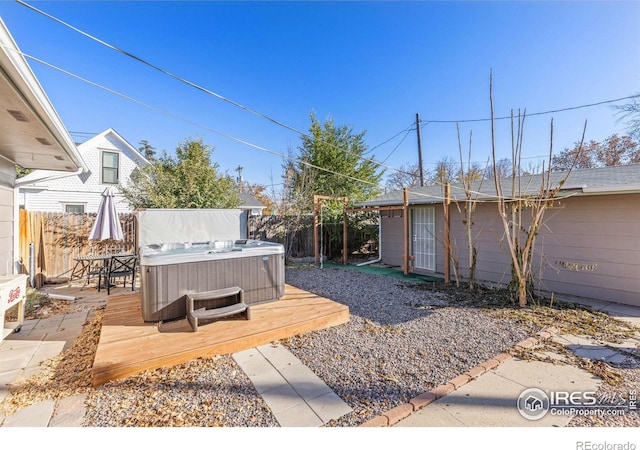 view of yard featuring a hot tub and a deck