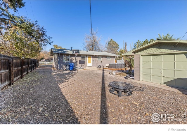 view of front facade featuring an outbuilding and an outdoor fire pit