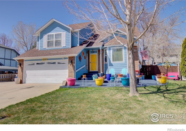 view of front of property with a patio area, a garage, and a front yard