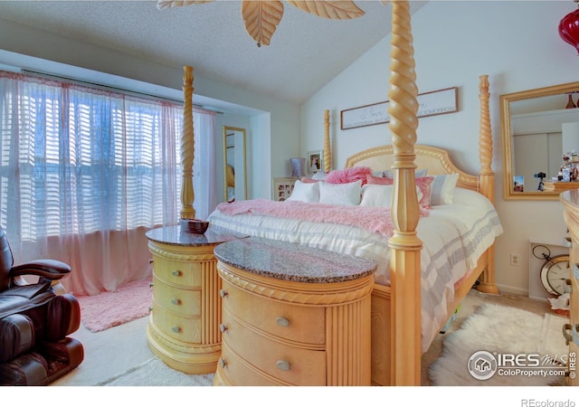 carpeted bedroom featuring a textured ceiling and lofted ceiling