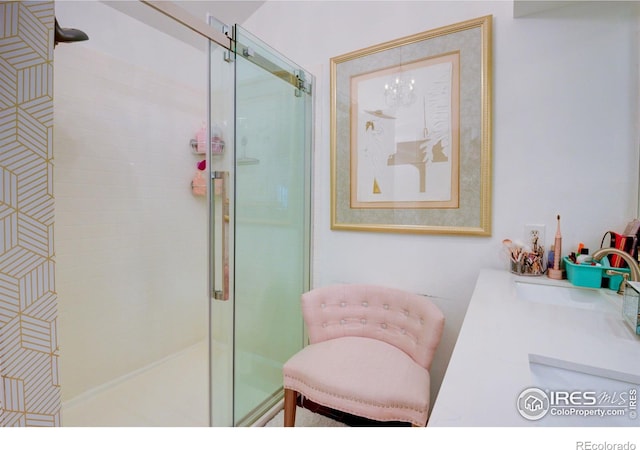 bathroom with a shower with door and a notable chandelier