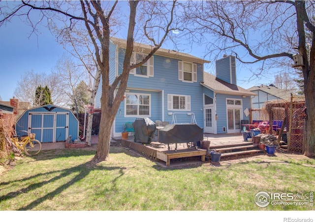 back of house with a lawn, a wooden deck, an outdoor living space, and a shed