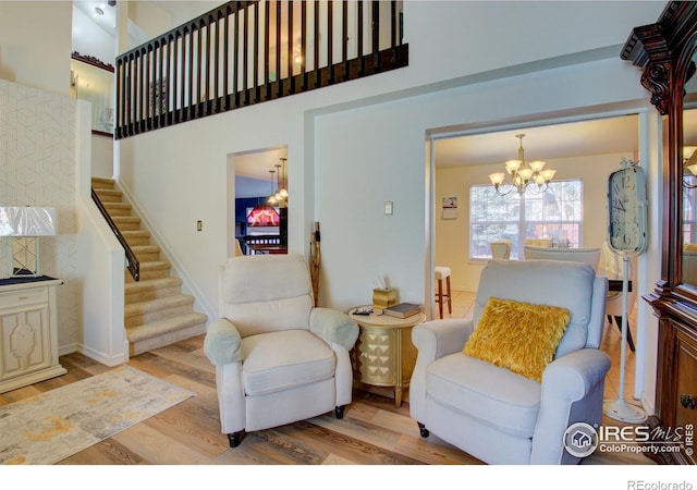 living room featuring light wood-type flooring and an inviting chandelier