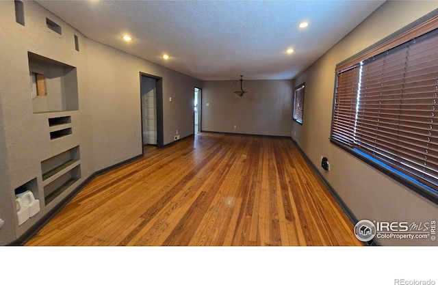 unfurnished living room with hardwood / wood-style flooring