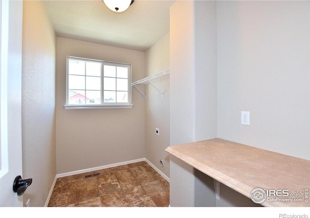 708 85th Avenue Ct, Greeley, CO 80634 - laundry area with hookup for an electric dryer, baseboards, and stone finish flooring