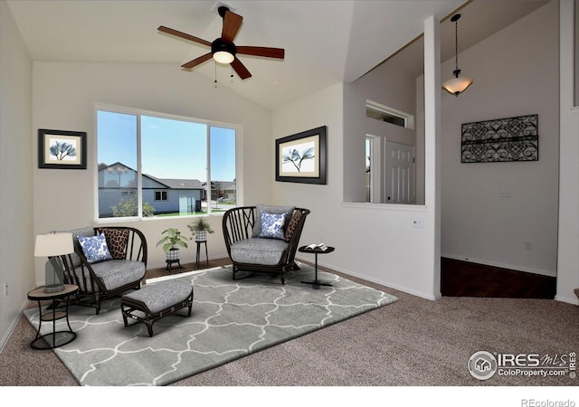 living area featuring ceiling fan, carpet, and lofted ceiling