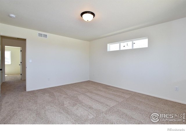 unfurnished room with light carpet