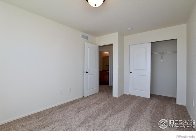 unfurnished bedroom with a closet and carpet floors