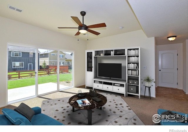 unfurnished living room with ceiling fan, visible vents, and carpet flooring