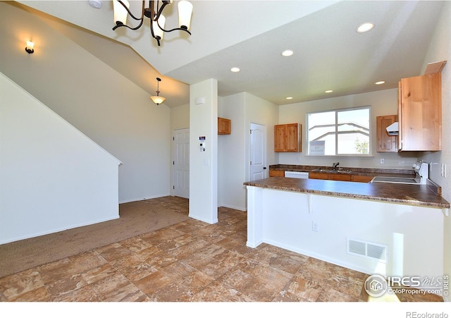 kitchen featuring dark countertops, recessed lighting, visible vents, stove, and a peninsula