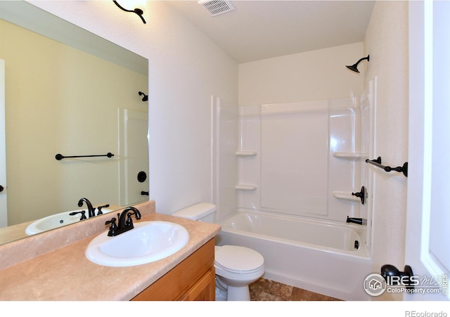 bathroom featuring toilet, bathtub / shower combination, visible vents, and vanity