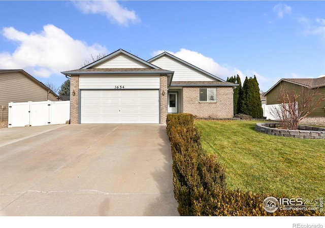 ranch-style house featuring a front yard and a garage