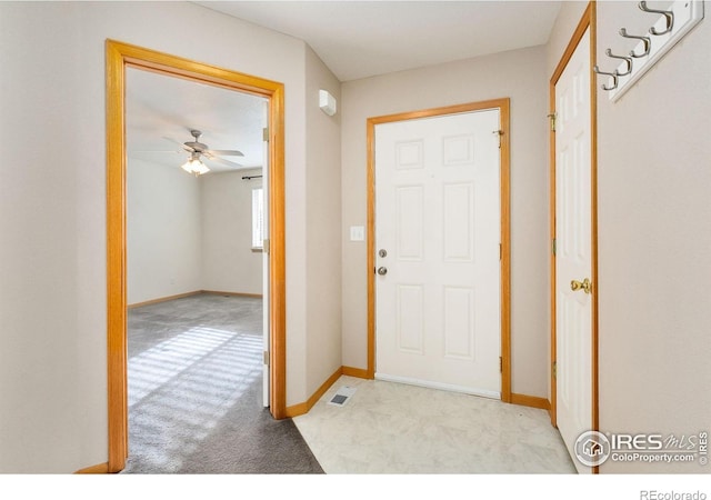 foyer entrance with light colored carpet