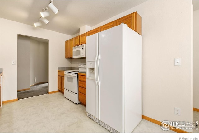 kitchen with white appliances and rail lighting