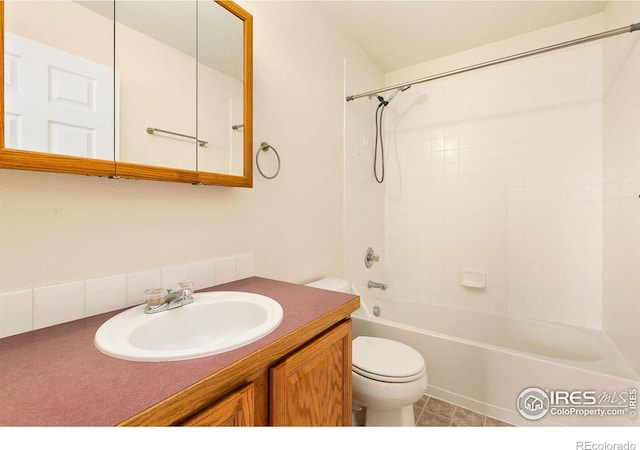 full bathroom with tile patterned flooring, vanity, toilet, and tiled shower / bath