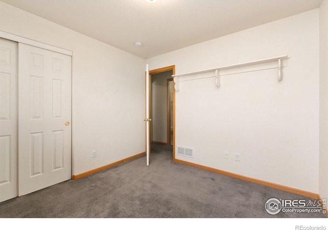 unfurnished bedroom featuring a closet and carpet flooring