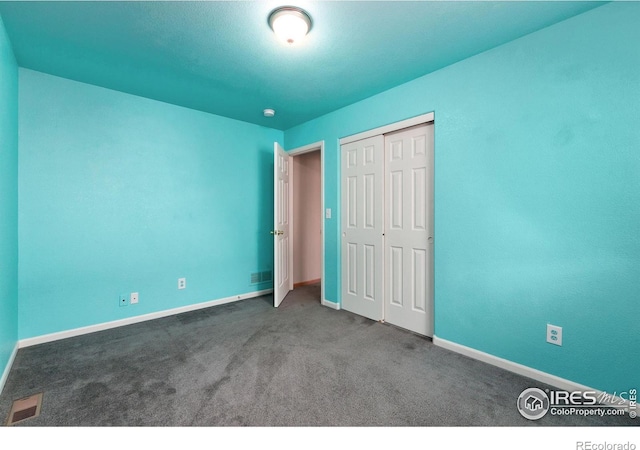 unfurnished bedroom with carpet floors and a closet