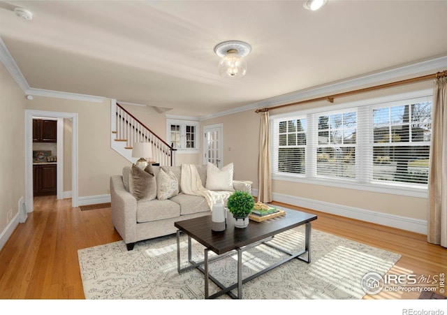 living room featuring wood-type flooring and ornamental molding