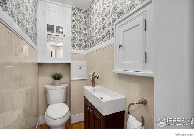 bathroom with hardwood / wood-style floors, vanity, and toilet