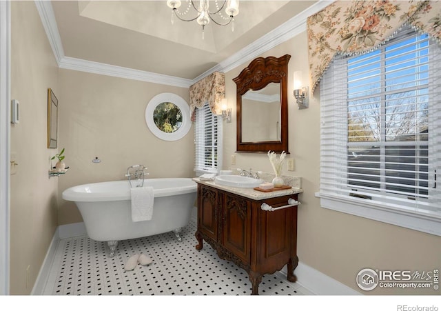 bathroom featuring a notable chandelier, vanity, crown molding, and a bath