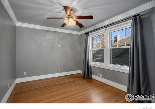 unfurnished room featuring hardwood / wood-style floors, ceiling fan, and crown molding