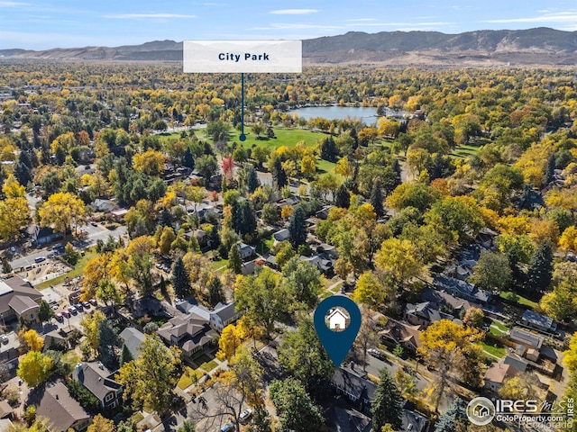 aerial view featuring a water and mountain view