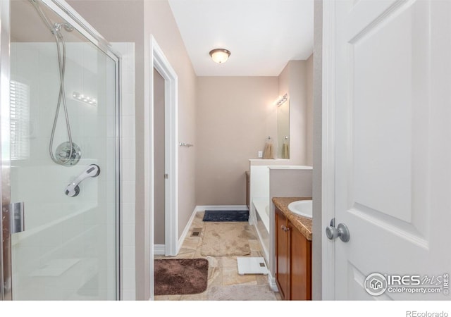 bathroom with vanity and a shower with shower door