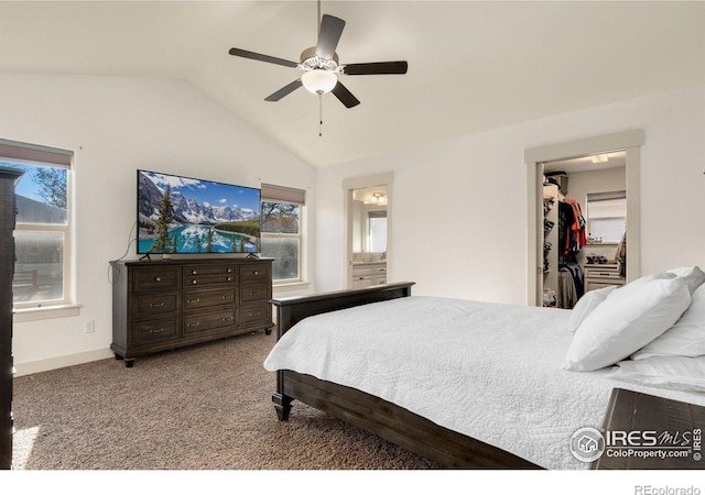 carpeted bedroom with lofted ceiling, ensuite bathroom, ceiling fan, a spacious closet, and a closet